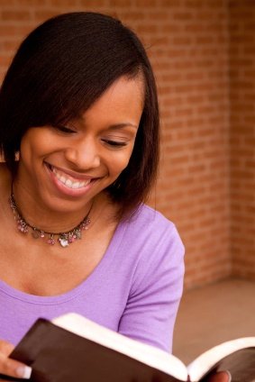 girl in purple reading Bible